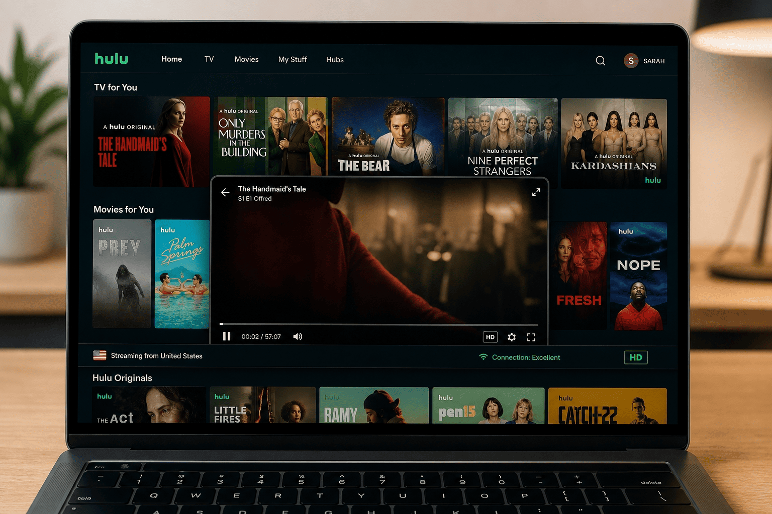 Hulu show library screen on a laptop with a video player starting playback, indicating a successful US-region connection